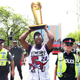 Kyle Lowry of the Toronto Raptors walks down the street with the NBA Championship trophy during the Toronto Raptors victory parade on June 17, 2019, in Toronto. Some 1 million people turned out for the celebration, which was marred when gunshots rang out leaving four people hurt. Police arrested three.